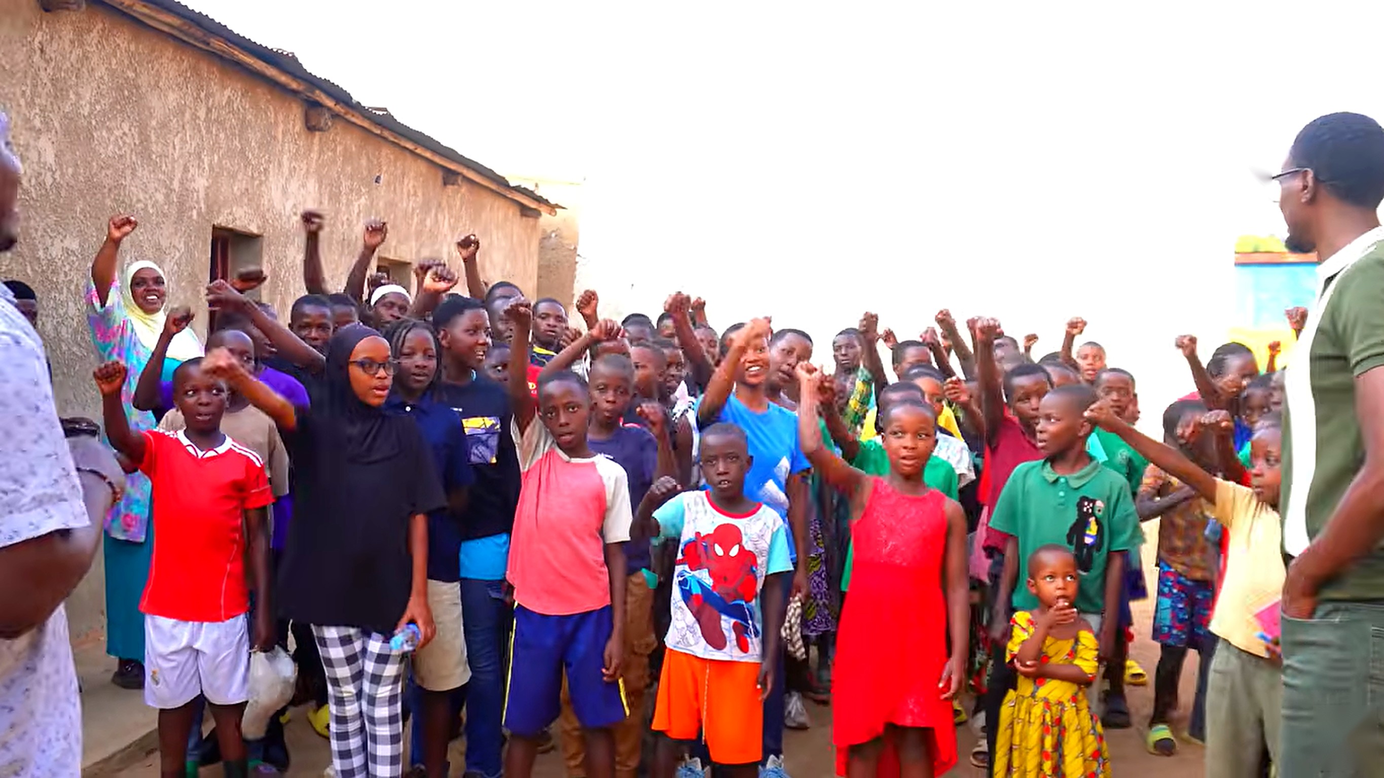 Children at Inzozi Learning Center in Gashora, Rwanda raising their hands together